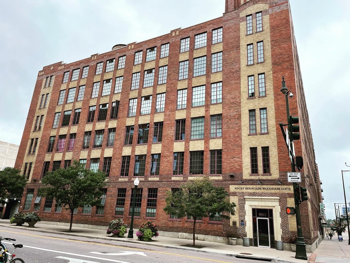 streetscape photo of a brick building with large windows