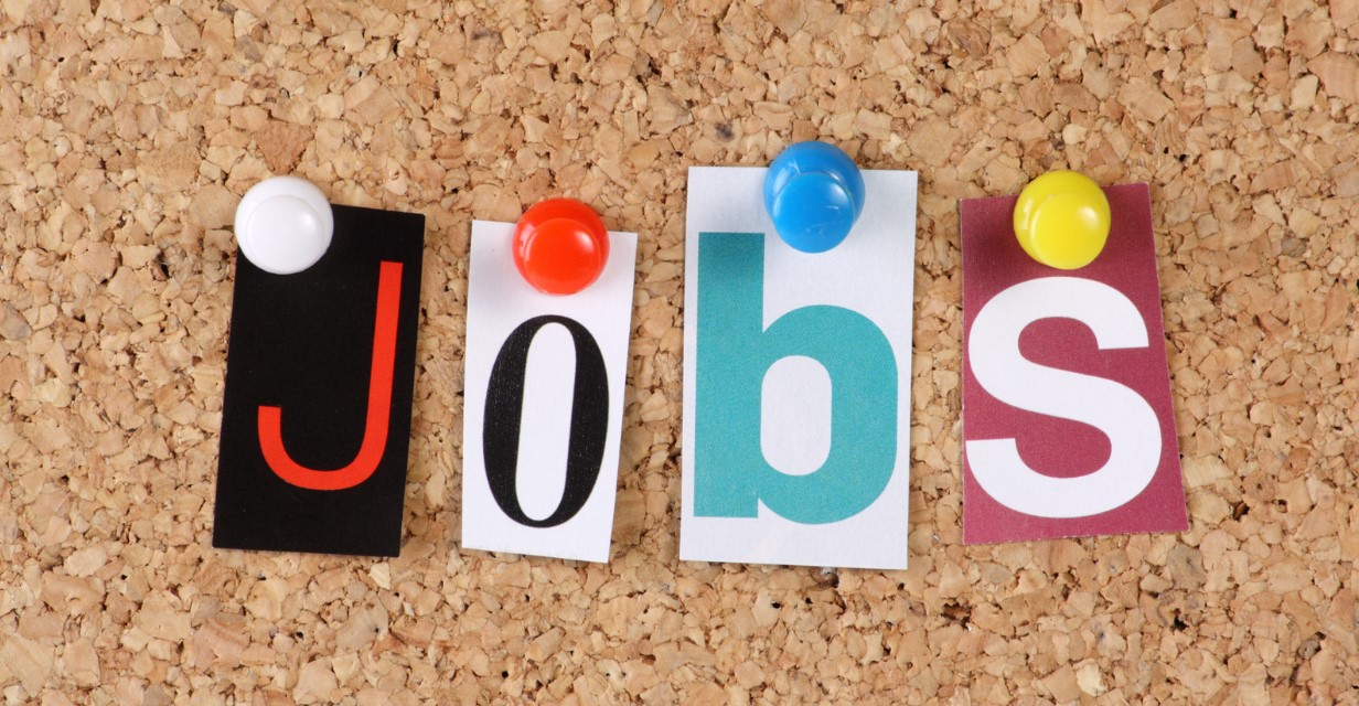 colorful letters pinned to a bulletin board spelling out Jobs